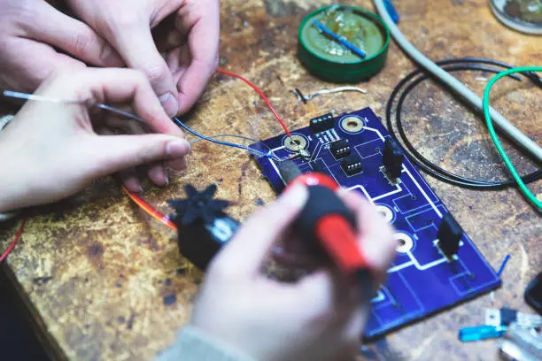 Component-level gaming repair — technician working on circuit board at Gaming Lab Durban